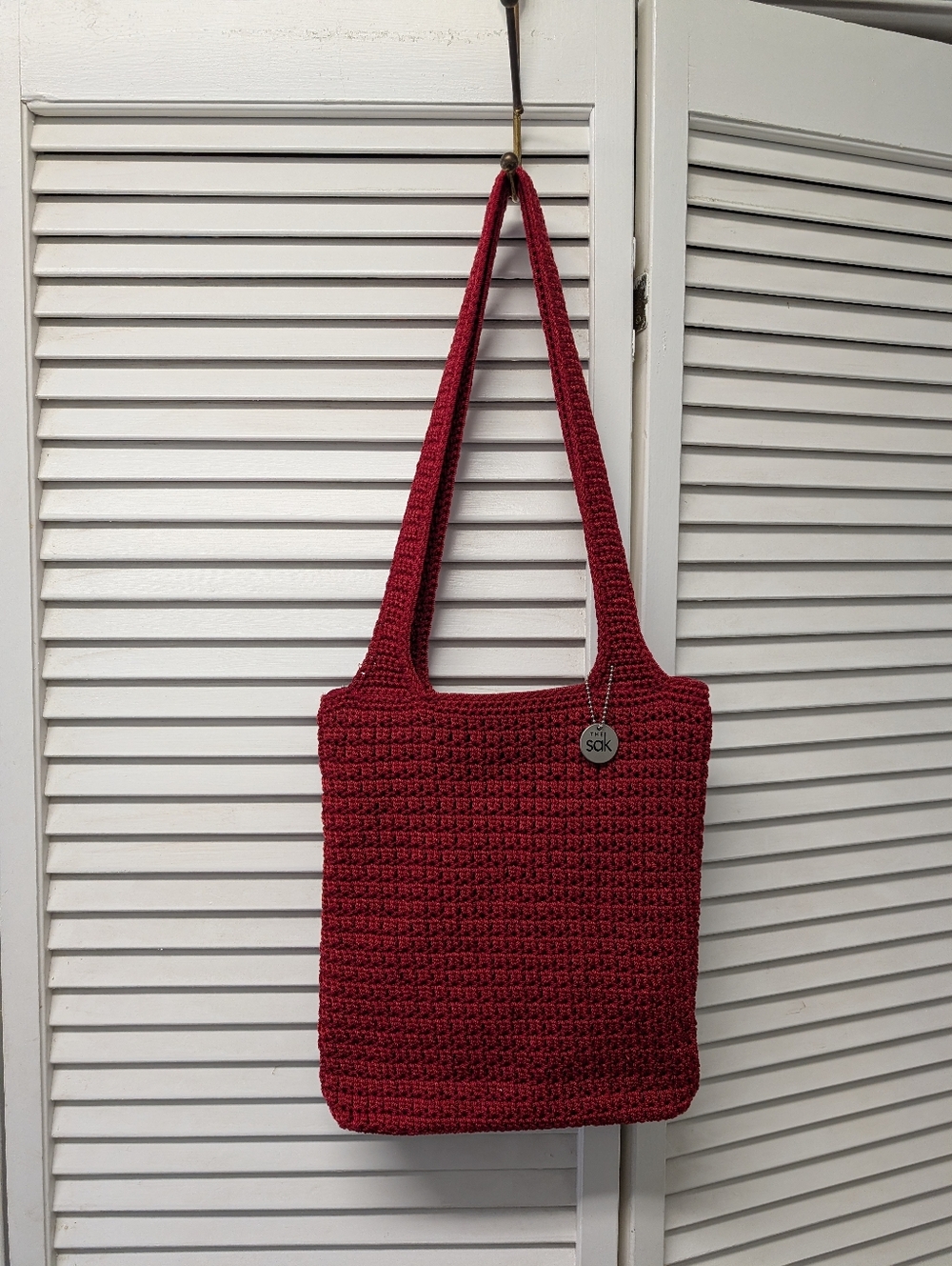 The Sak Red Crochet Shoulder Bag with Pendant Charm